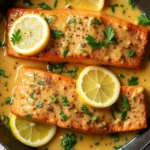 Creamy garlic salmon with fresh parsley on a white plate.