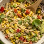 Shredding cooked chicken breast for Mexican Chicken Salad